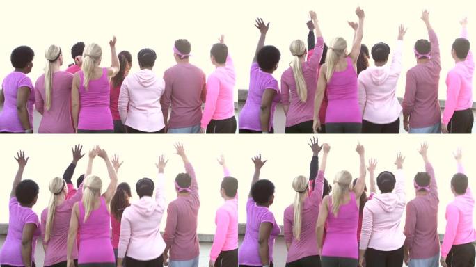 穿着粉色衣服的男人和女人站在一起，挥手，跳跃