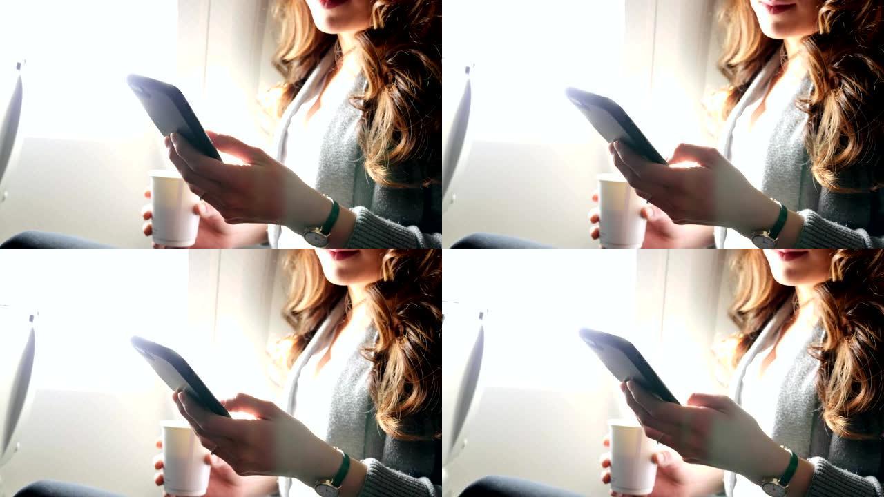 年轻女子在飞机上浏览智能手机