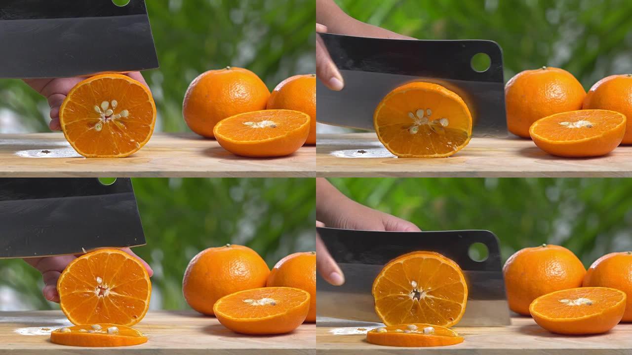 在木制砧板上切割橙色切片的4k。