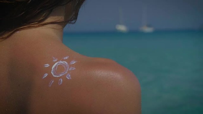 年轻漂亮的女孩使用面霜来保护自己免受阳光的紫外线照射，保护皮肤免受年龄和面霜的侵害