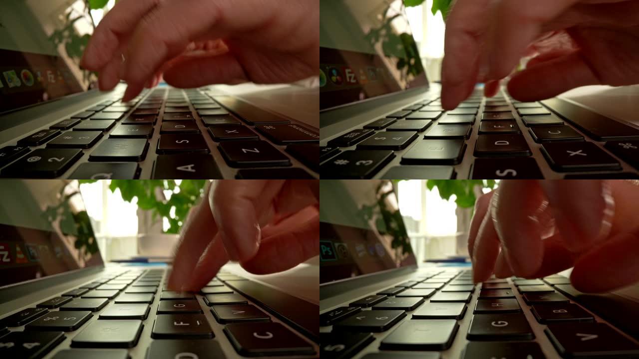 有人在笔记本电脑的键盘上打字，按下按钮进行在线交流，编码和编程软件，在家工作。UHD滑块镜头