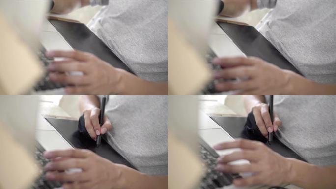 亚洲男子专业设计师使用图形平板电脑在创意办公室工作