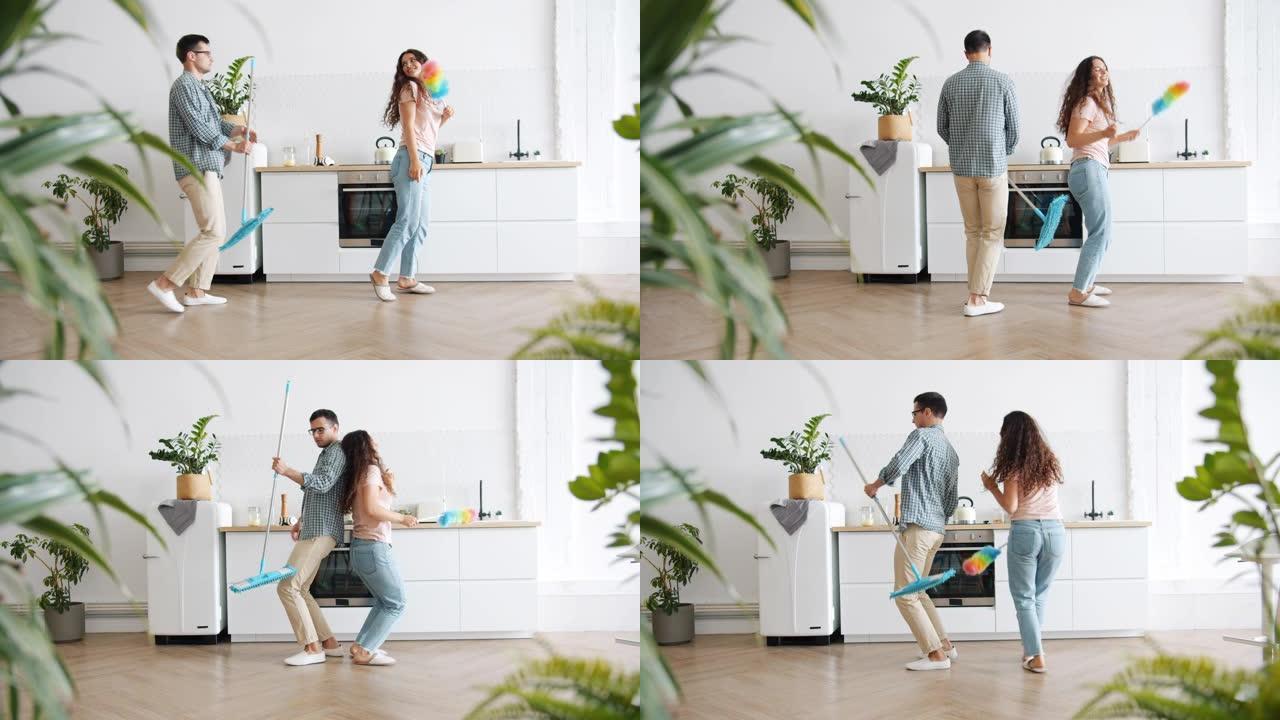 用拖把和除尘器清理时，家庭在厨房里跳舞的慢动作