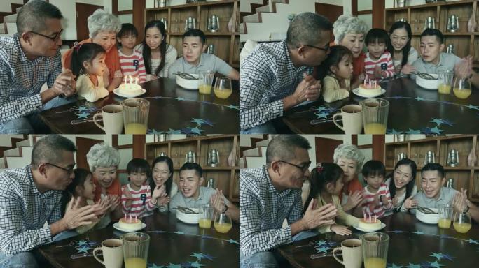 多代华人家庭吹生日蛋糕蜡烛