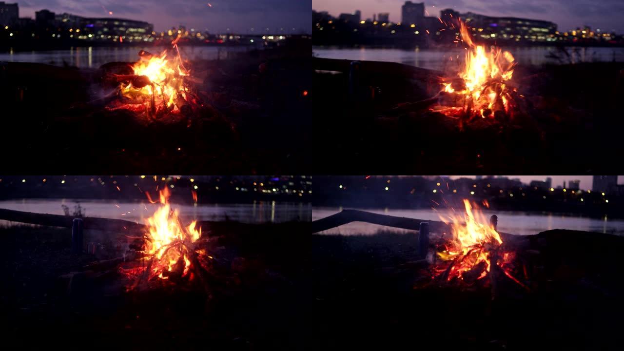 河边燃烧着篝火。背景中的城市