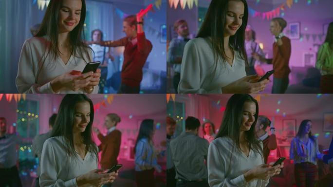 在野外聚会上: 美丽的年轻女孩使用智能手机，通过互联网和社交网络浏览。在背景人群中，年轻人跳舞，玩得