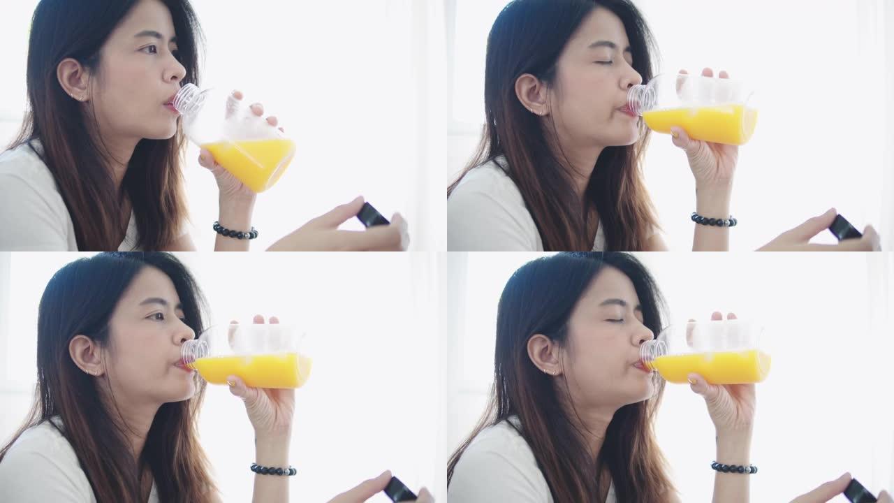 微笑的女人喝一杯橙汁