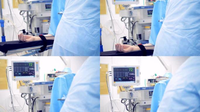 在手术过程中，患者的手与医疗监护仪相连