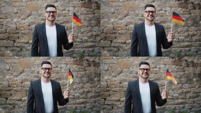 慢动作肖像微笑的德国人与德国国旗