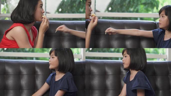 两个妹妹亚洲年轻女孩喜欢在家吃饼干