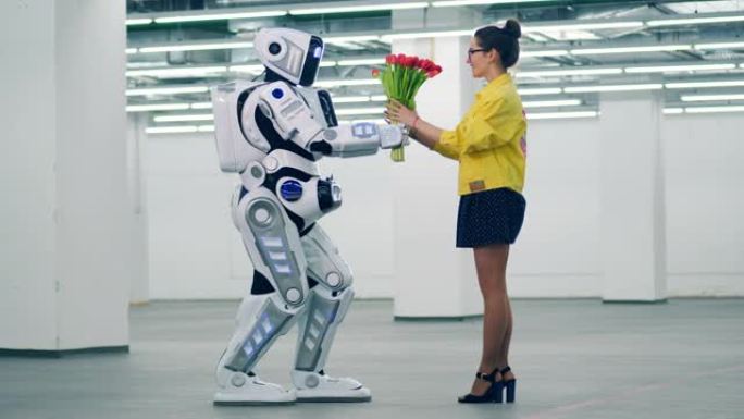 高大的机器人正在空荡荡的大厅里给女人送花