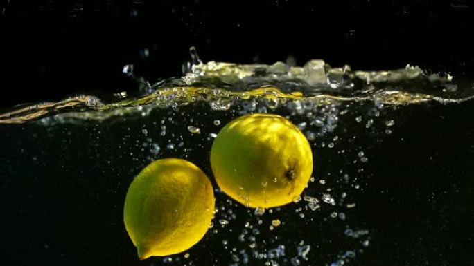 黄色柠檬。落水的水果。慢动作