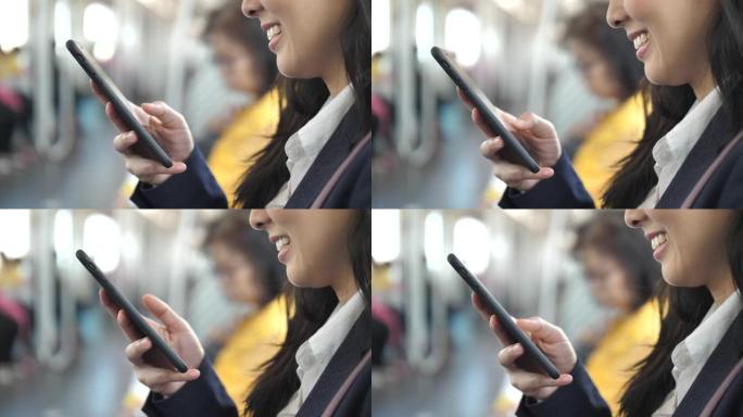 在地铁列车上使用智能手机的特写女商人