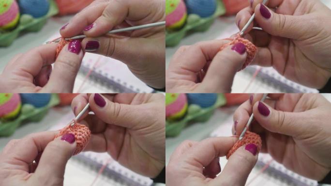 用线和钩针缝制女人的手的特写。