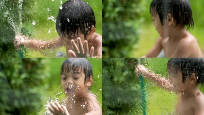 4k实时顽皮的男孩在花园里的湿玻璃后面玩耍