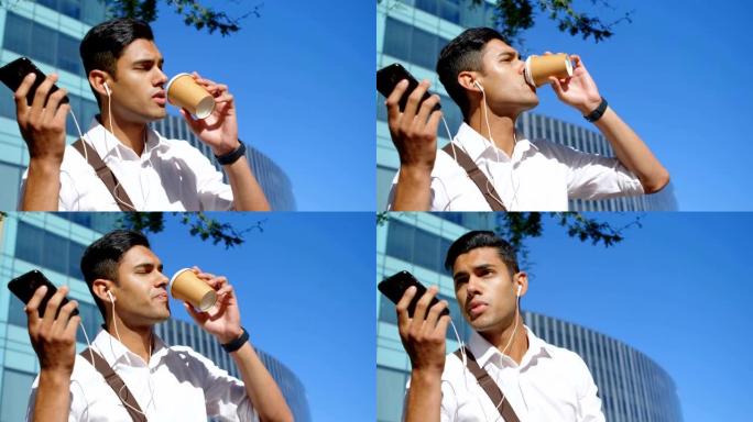 男子在手机上聊天时喝咖啡4k
