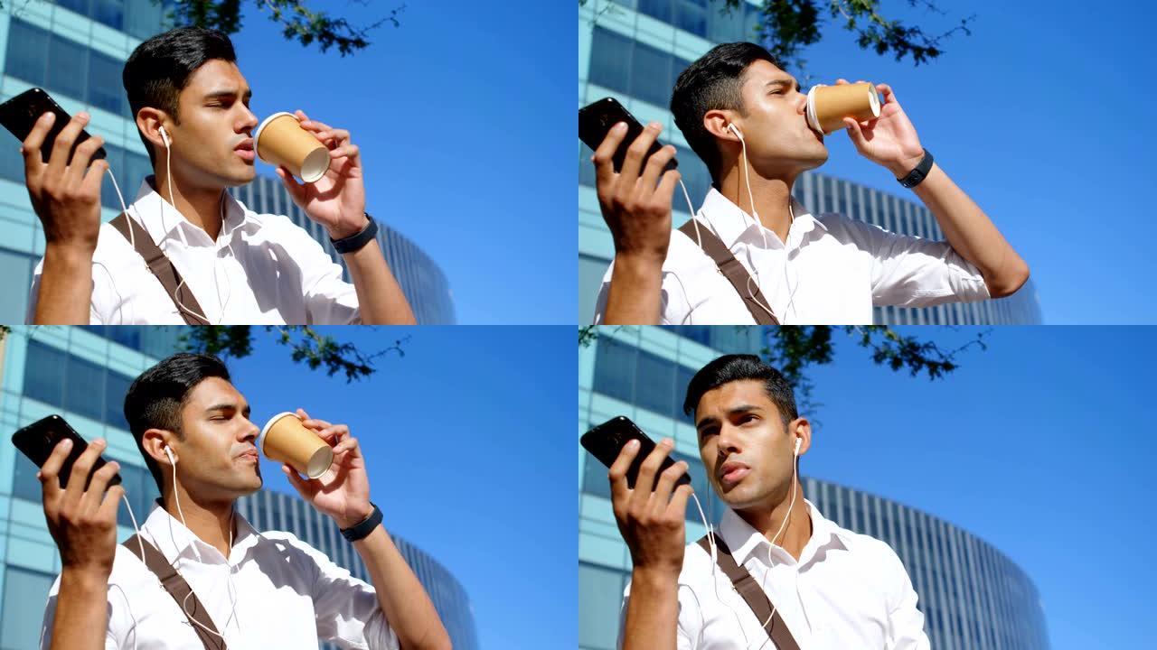 男子在手机上聊天时喝咖啡4k