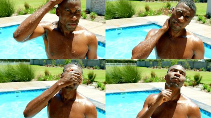 站在4k度假村游泳池里的年轻黑人男子的前视图