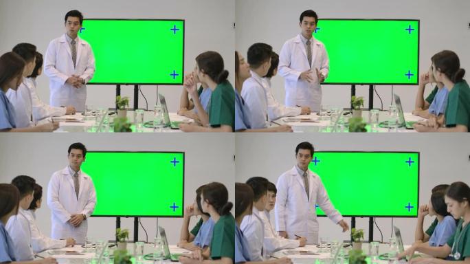4k医学研究团队在一次会议上，医生在医院的视频会议上使用绿屏监视器进行演示。