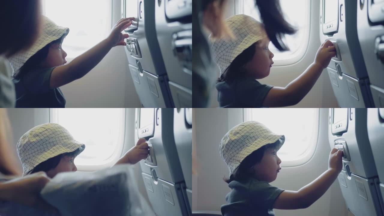 亚洲男婴在飞行中观看飞机电视