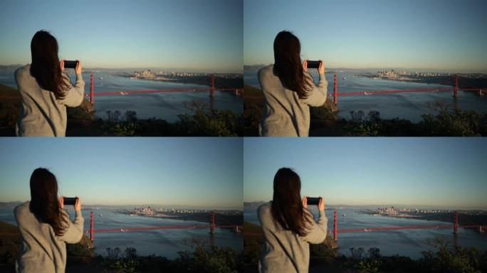 拍摄旧金山金门大桥的女人
