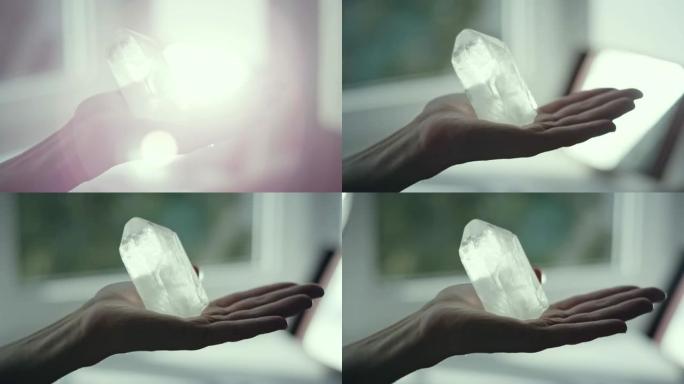 女人的手有愈合的水晶。