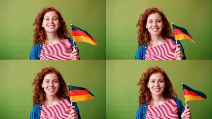 迷人的德国少女手持德国国旗微笑