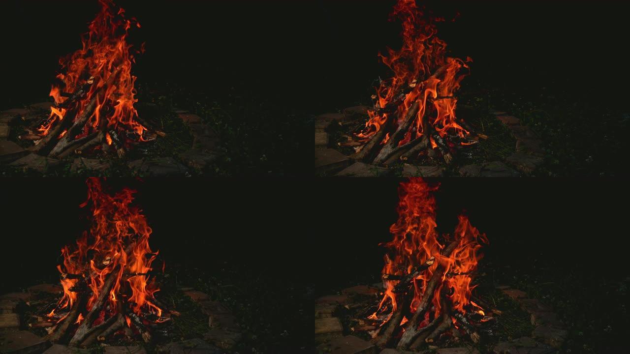 慢动作: 篝火在营地附近的砖砌火坑内crack啪作响
