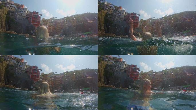 MS慢动作无忧无虑的年轻女子在海上跳起来，五渔村，意大利