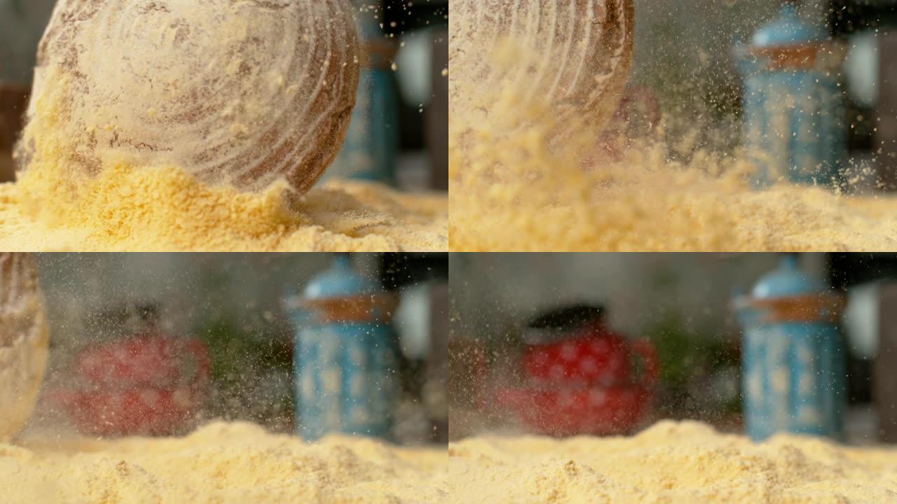 宏观，DOF: 质朴的棕色面包落入一堆粗玉米粉中。