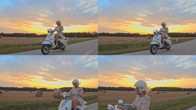 日落时在乡下骑踏板车的SLO MO女人