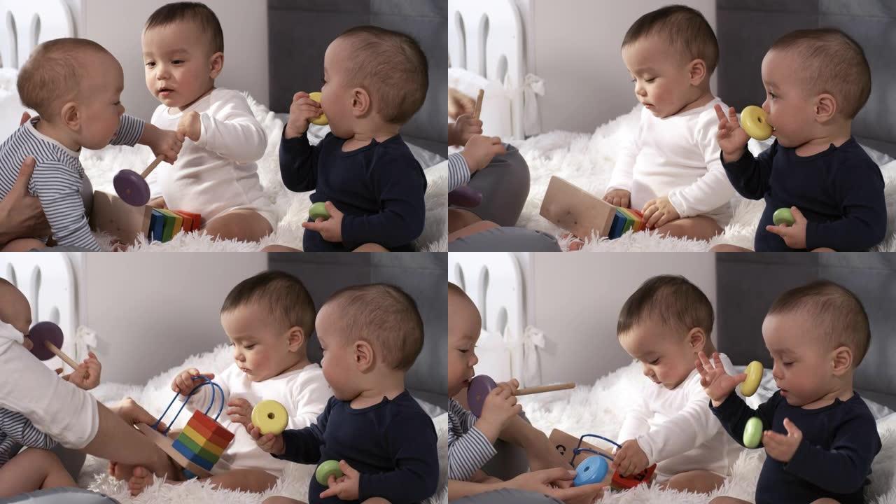 亚洲三胞胎婴儿坐在卧室里玩玩具