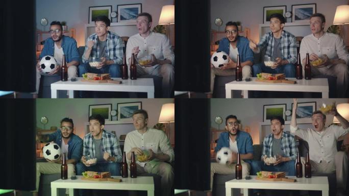 帅哥在电视上观看足球比赛，吃零食庆祝胜利