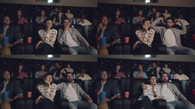 约会时在电影院里拥抱快乐的女朋友一起看电影的家伙