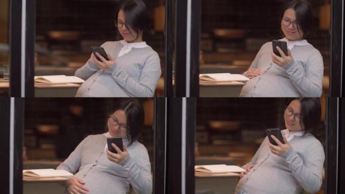 中国孕妇在手机上看书