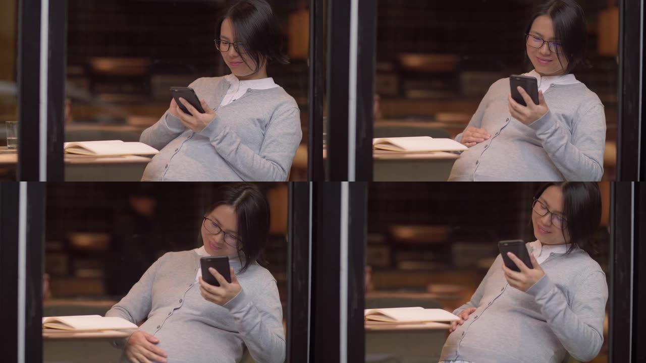 中国孕妇在手机上看书