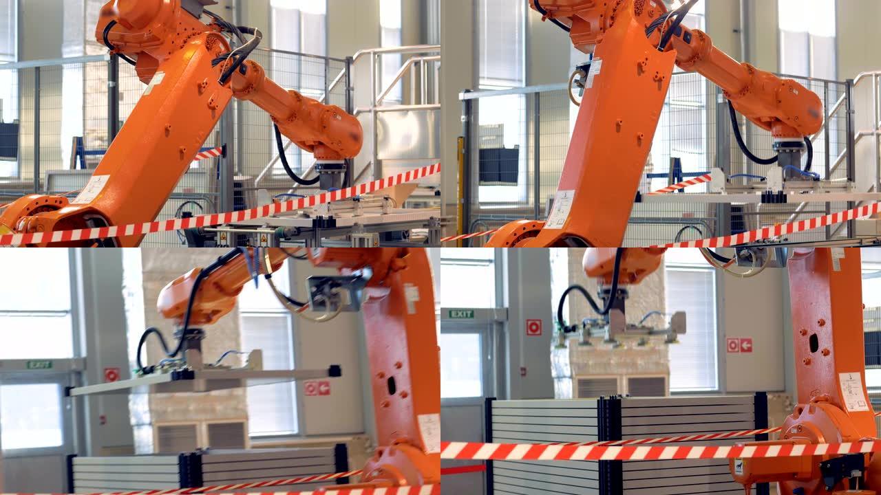 自动化工厂机器，在传送带上工作的机器人臂。