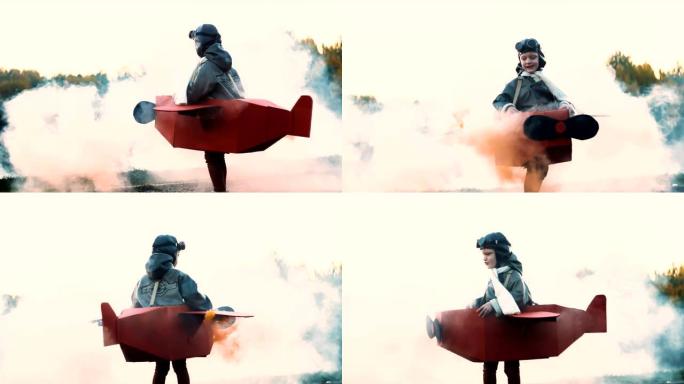 快乐的小飞行员男孩穿着有趣的纸板飞机服装旋转，红色烟雾梦想着慢动作飞行。