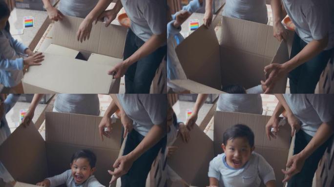 男孩跳出纸板箱使家人感到惊讶