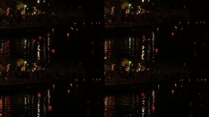 在节日的夜晚，游客沿着充满东方纸灯的河流漫步。