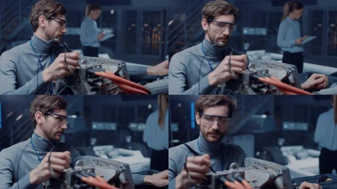 专业的汽车工程师在眼镜与计算机和检查工具正在测试使用的电动发动机在高科技实验室与概念车底盘。