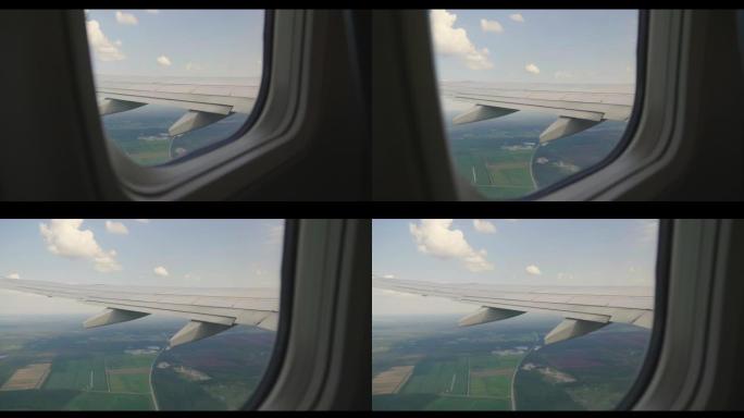 从飞机内部可以看到白云和飞机机翼的天空。