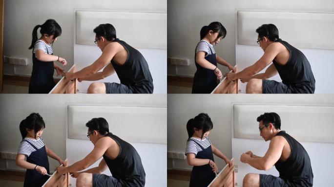 一个亚洲华人家庭搬家女儿帮助父亲组装床架