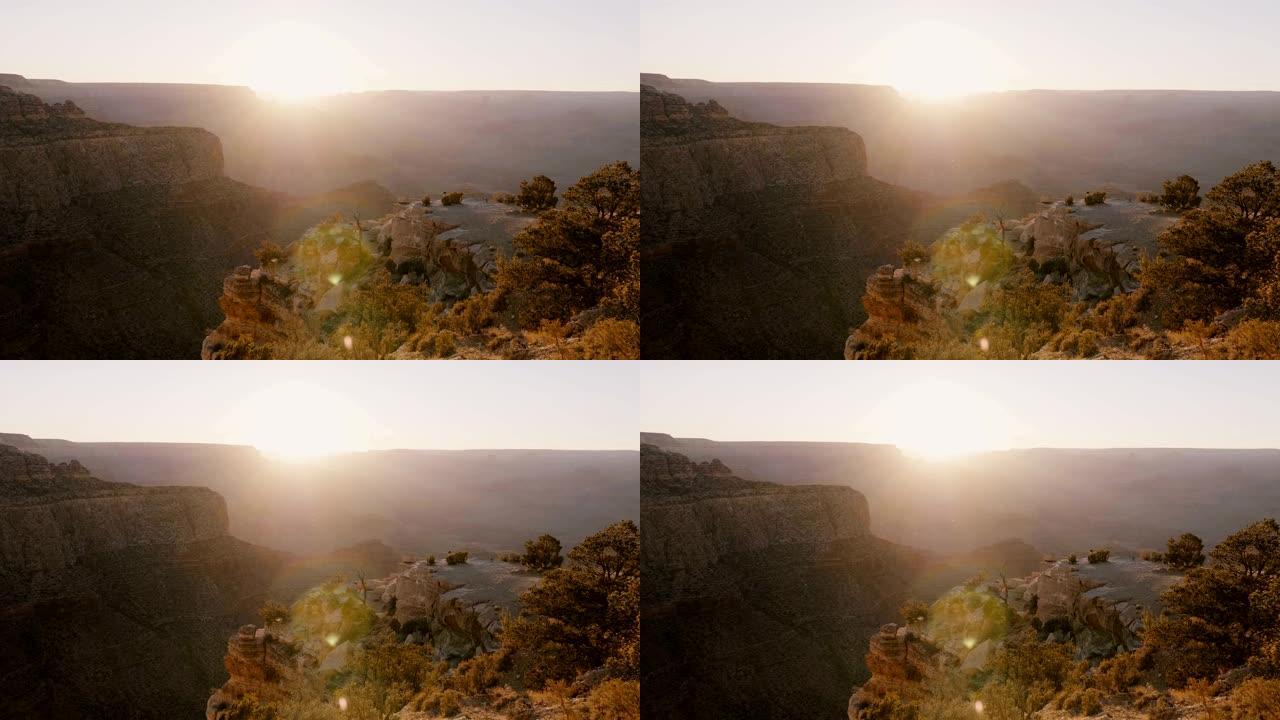 史诗镜头耀斑日落全景，太阳在美国亚利桑那州大峡谷国家公园的惊人山脉上落下。