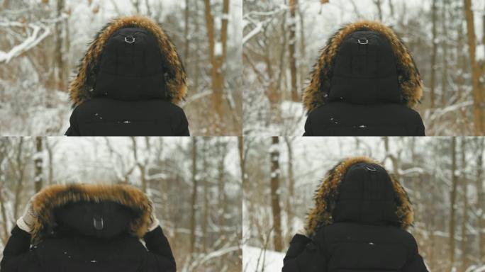 在下雪的冬天，穿着山羊大衣的美丽年轻女子