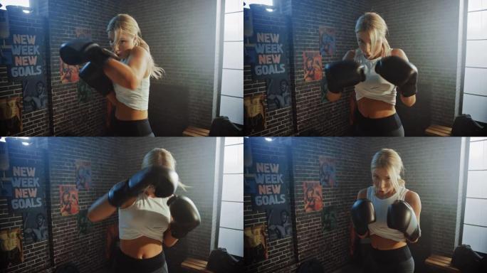 职业女战士的肖像在铁杆健身房穿着运动服和格斗手套练习踢打空气。强壮美丽的女孩跆拳道和自卫锻炼