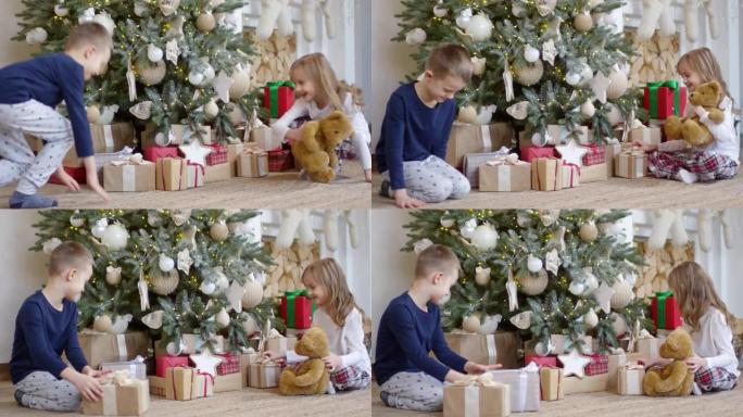 小孩子跑到圣诞树前拿礼物