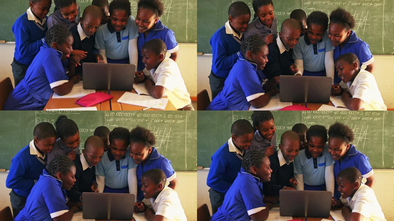 在乡镇学校的一堂课中使用笔记本电脑的学童4k