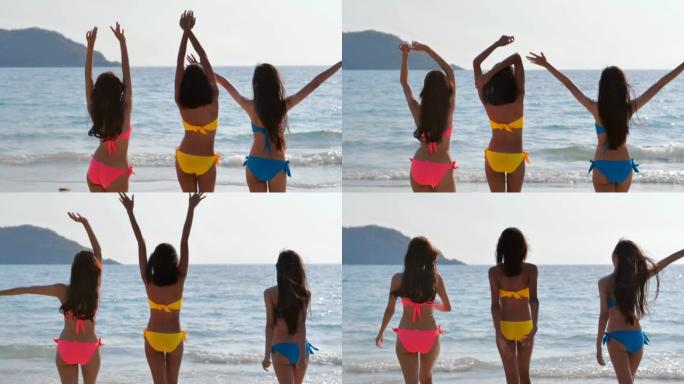 三个漂亮的女孩在海滩上散步和玩耍。假期-iStock