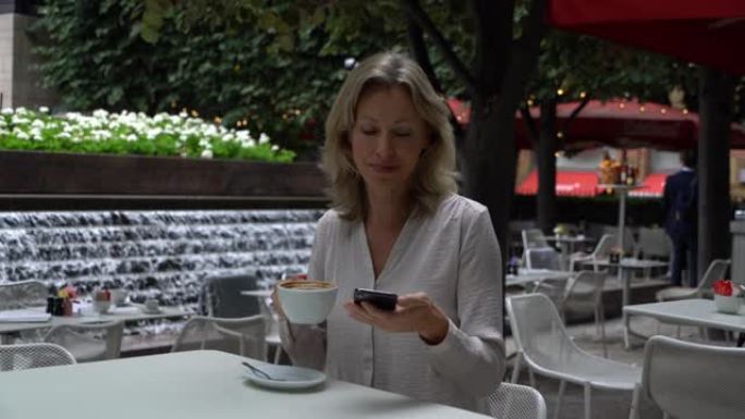 Beautiful woman enjoying a cup of coffee at a cafe